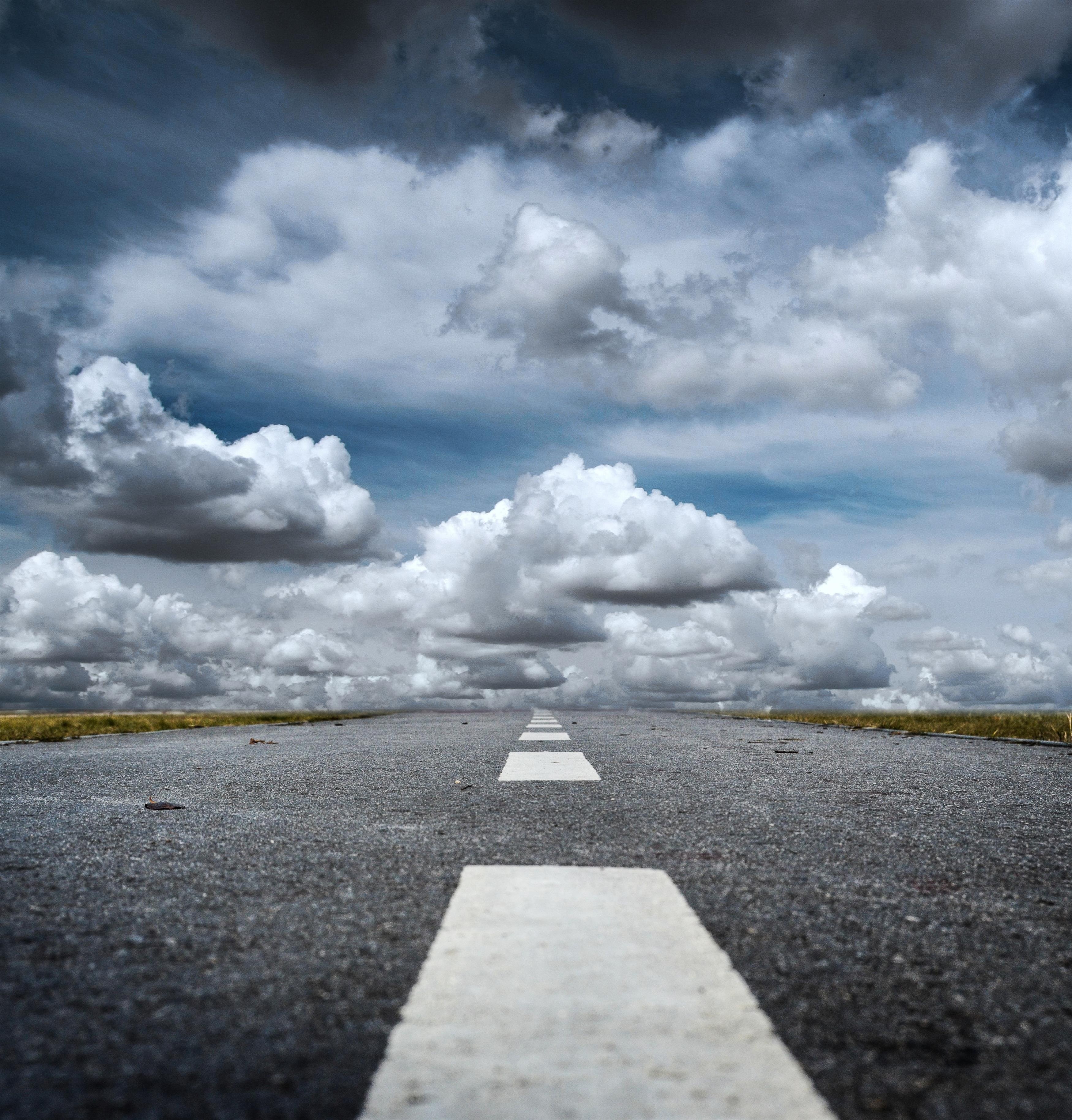 Clouds covering a long road